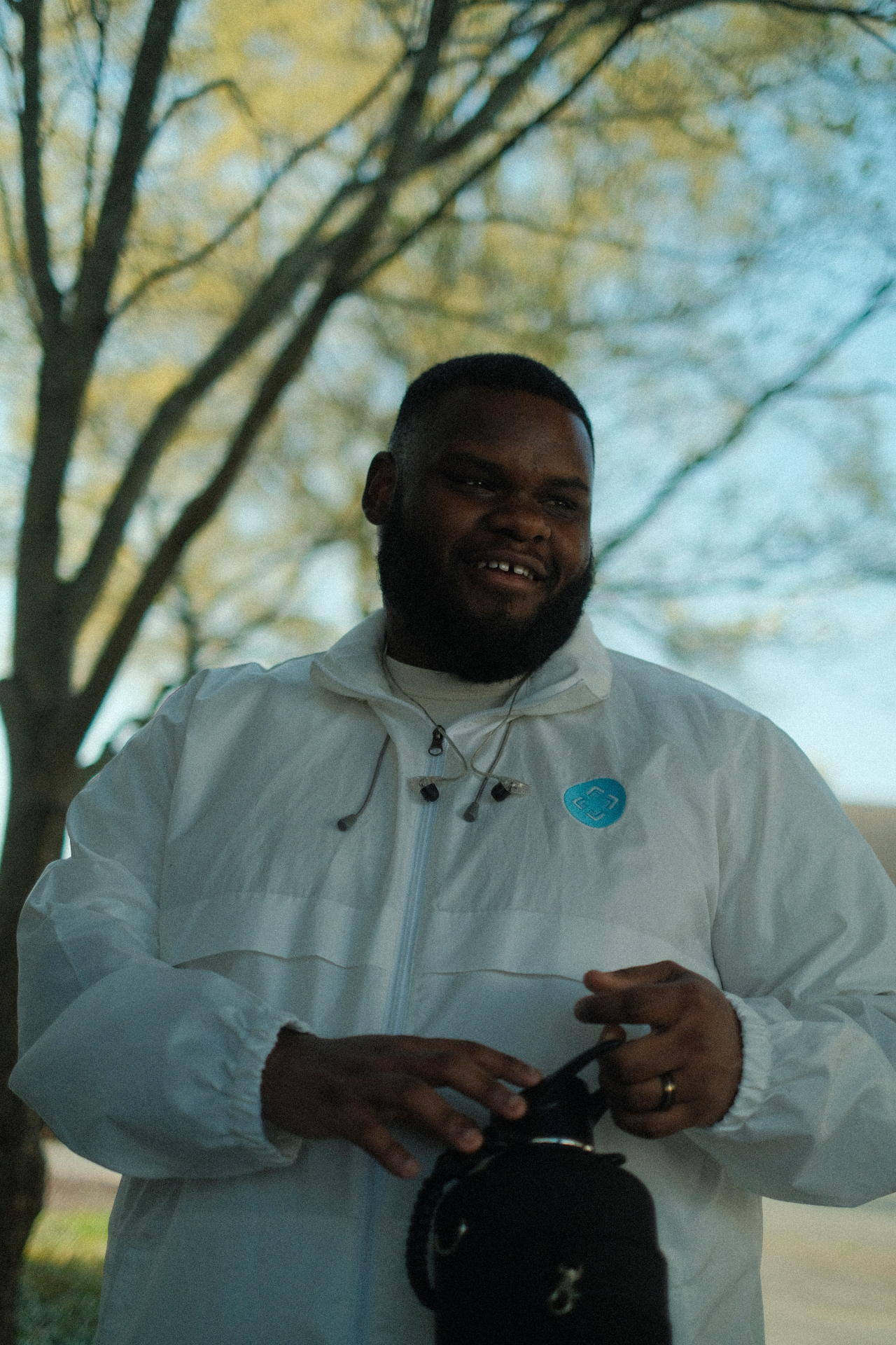 Darius Walton, photographer based in Mooresville NC, holding his camera outdoors